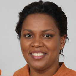 Joyful black adult female with short  brown hair and brown eyes