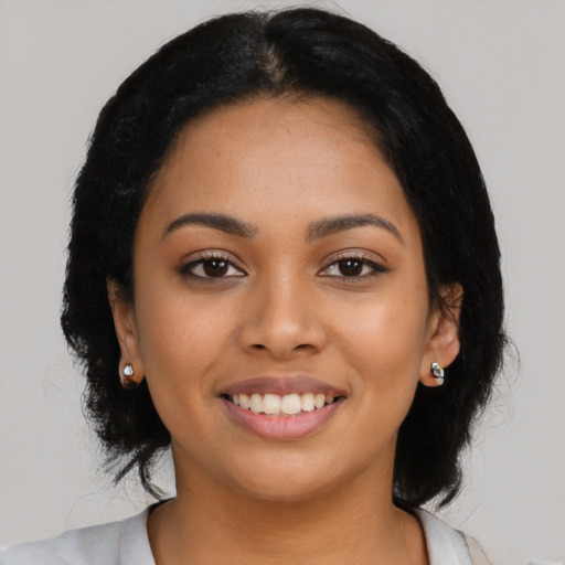 Joyful latino young-adult female with medium  black hair and brown eyes