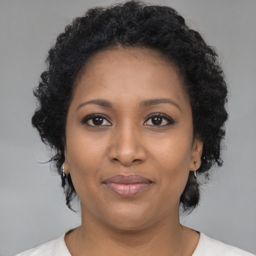 Joyful black young-adult female with medium  black hair and brown eyes