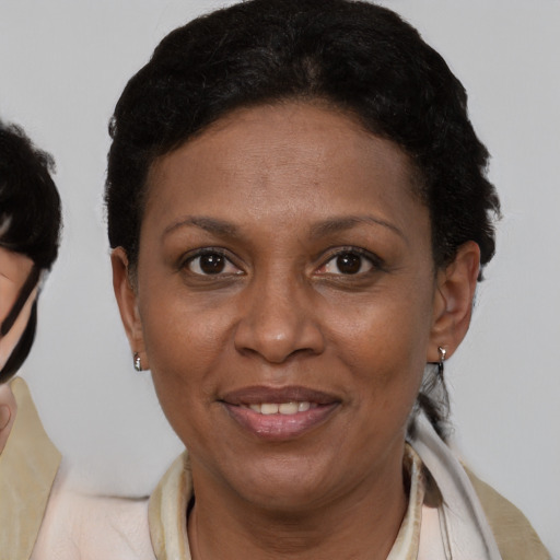 Joyful latino adult female with short  brown hair and brown eyes