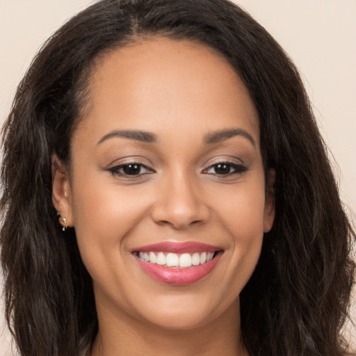 Joyful white young-adult female with long  brown hair and brown eyes