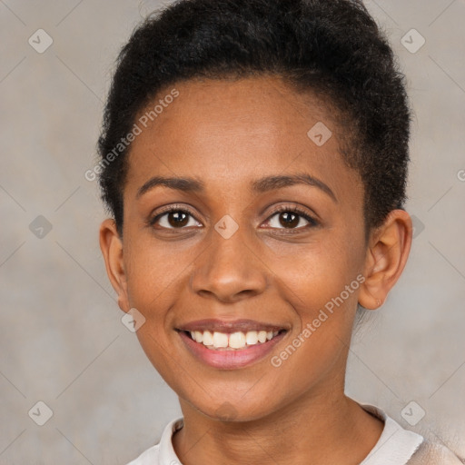 Joyful black young-adult female with short  brown hair and brown eyes