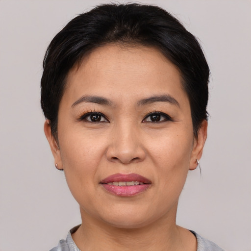 Joyful asian young-adult female with short  black hair and brown eyes