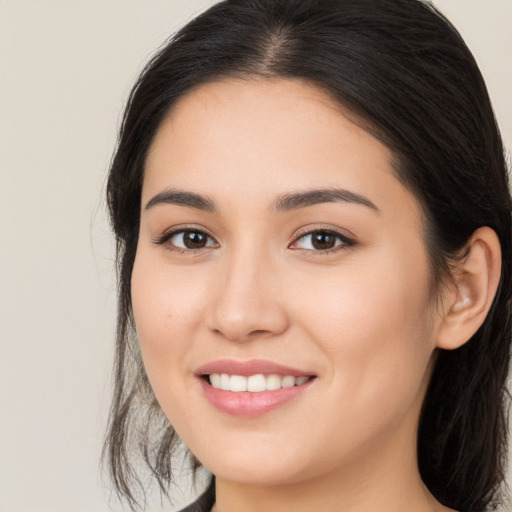 Joyful white young-adult female with long  brown hair and brown eyes