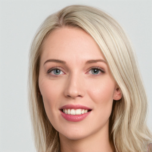 Joyful white young-adult female with long  brown hair and blue eyes