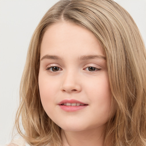 Joyful white child female with long  brown hair and brown eyes