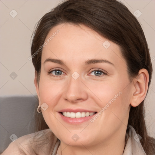 Joyful white young-adult female with medium  brown hair and grey eyes