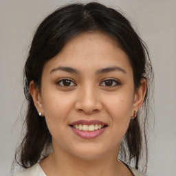 Joyful latino young-adult female with medium  brown hair and brown eyes