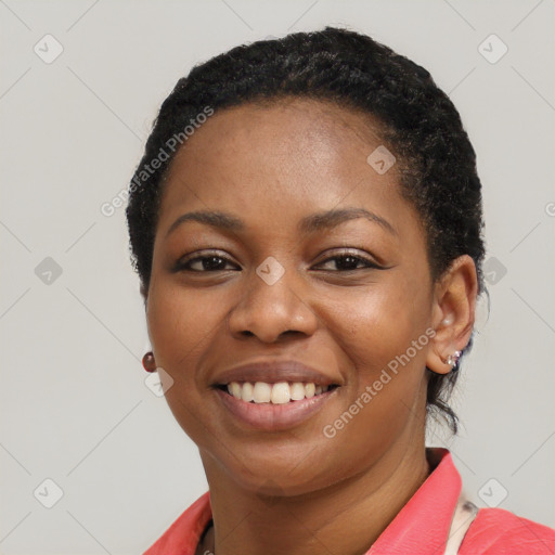 Joyful black young-adult female with short  black hair and brown eyes