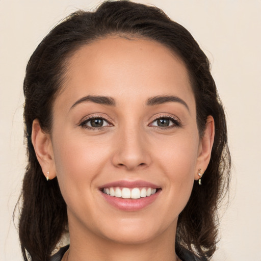 Joyful white young-adult female with long  brown hair and brown eyes