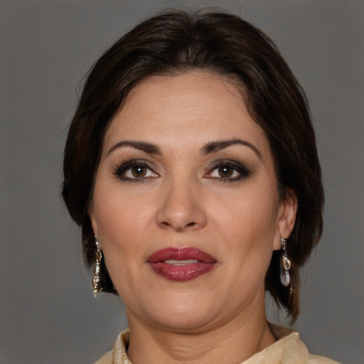 Joyful white adult female with medium  brown hair and brown eyes