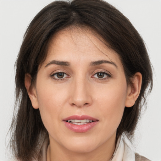 Joyful white adult female with medium  brown hair and brown eyes