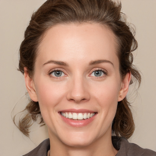 Joyful white young-adult female with medium  brown hair and green eyes