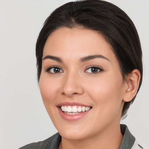 Joyful white young-adult female with medium  brown hair and brown eyes