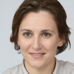 Joyful white adult female with medium  brown hair and brown eyes