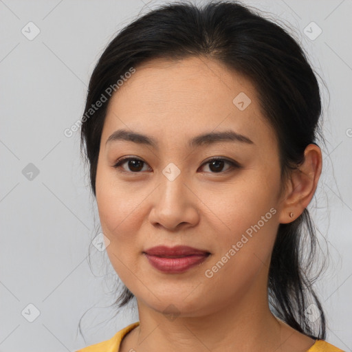 Joyful asian young-adult female with medium  brown hair and brown eyes