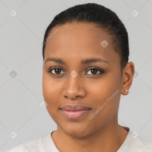 Joyful black young-adult female with short  black hair and brown eyes