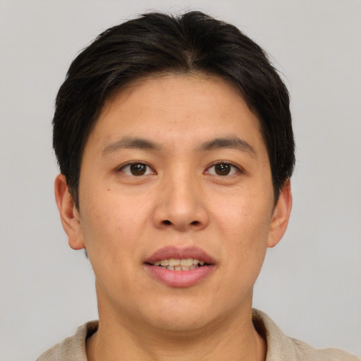 Joyful asian young-adult male with short  brown hair and brown eyes