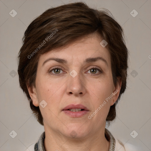 Joyful white adult female with medium  brown hair and grey eyes