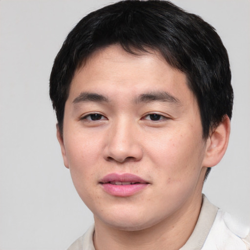 Joyful asian young-adult male with short  black hair and brown eyes