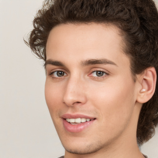 Joyful white young-adult male with medium  brown hair and brown eyes