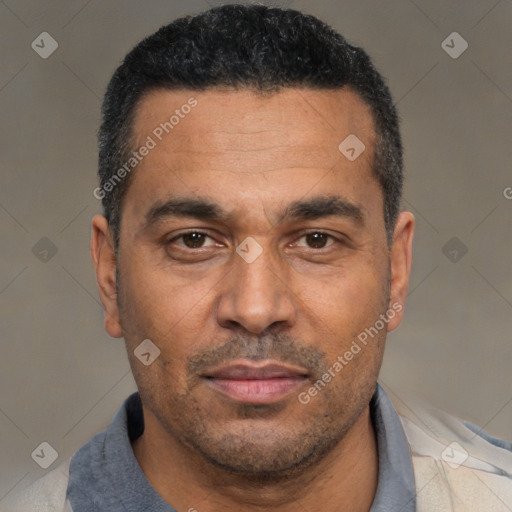 Joyful black adult male with short  black hair and brown eyes