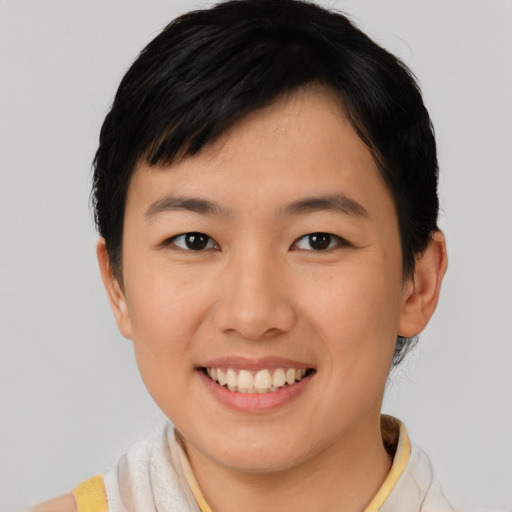 Joyful asian young-adult female with short  brown hair and brown eyes