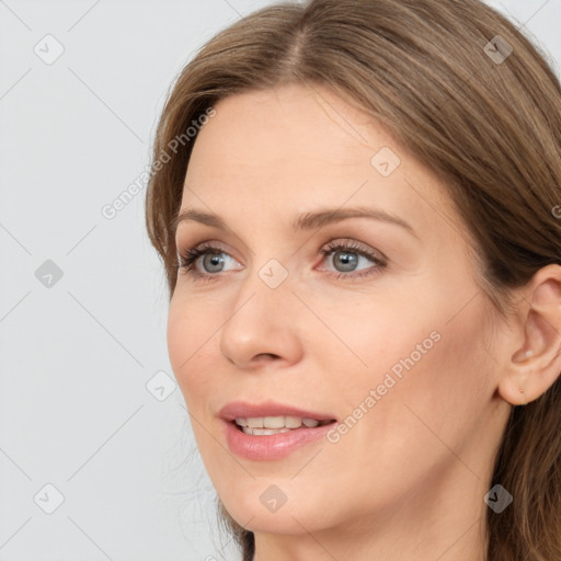 Joyful white young-adult female with long  brown hair and blue eyes