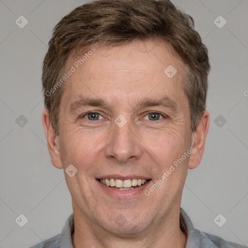 Joyful white adult male with short  brown hair and grey eyes