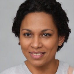 Joyful black adult female with short  brown hair and brown eyes