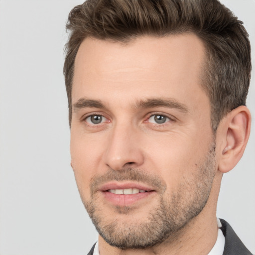 Joyful white adult male with short  brown hair and brown eyes