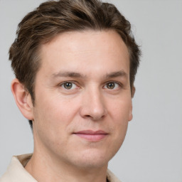 Joyful white adult male with short  brown hair and grey eyes