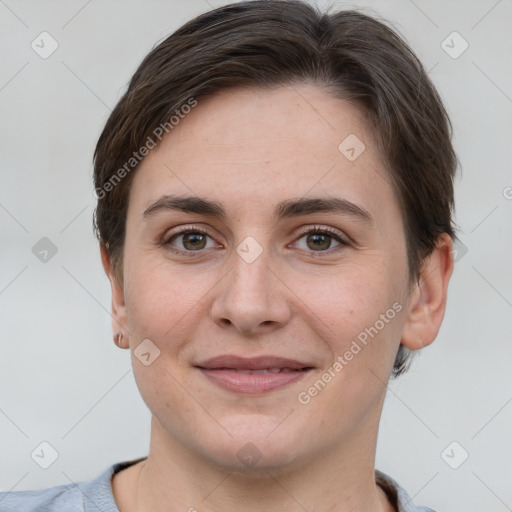 Joyful white young-adult female with short  brown hair and grey eyes