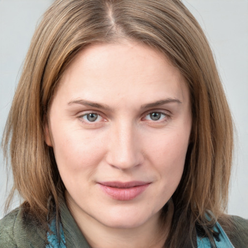 Joyful white young-adult female with medium  brown hair and blue eyes