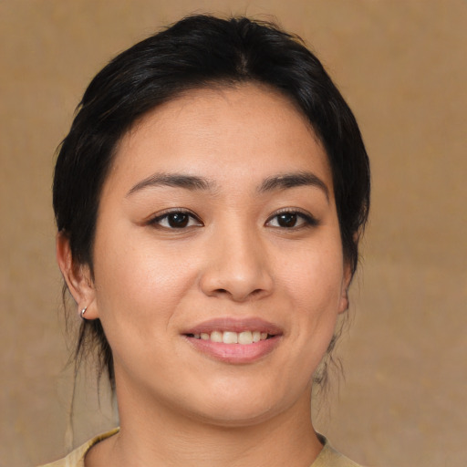 Joyful asian young-adult female with medium  brown hair and brown eyes