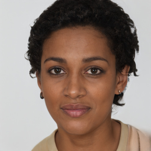 Joyful black young-adult female with short  brown hair and brown eyes
