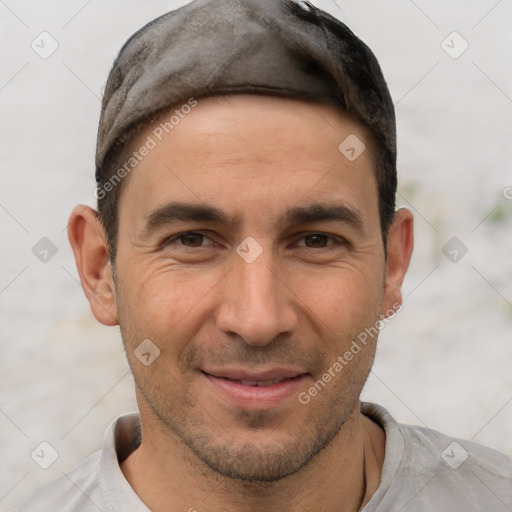 Joyful white adult male with short  brown hair and brown eyes