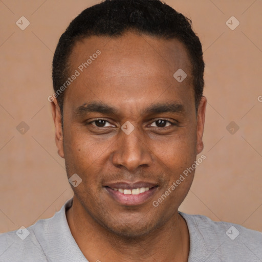 Joyful latino young-adult male with short  brown hair and brown eyes