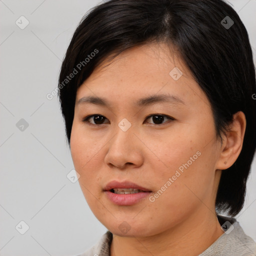 Joyful asian young-adult female with medium  black hair and brown eyes
