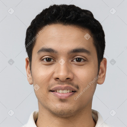 Joyful latino young-adult male with short  black hair and brown eyes