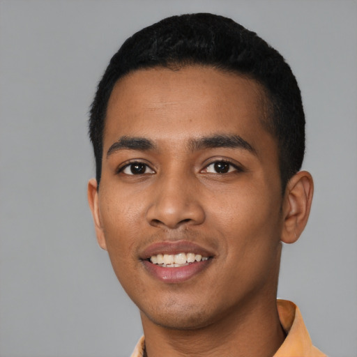 Joyful black young-adult male with short  black hair and brown eyes
