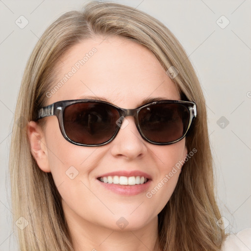 Joyful white young-adult female with long  brown hair and blue eyes