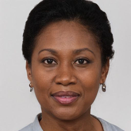 Joyful black adult female with short  brown hair and brown eyes