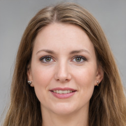 Joyful white young-adult female with long  brown hair and grey eyes