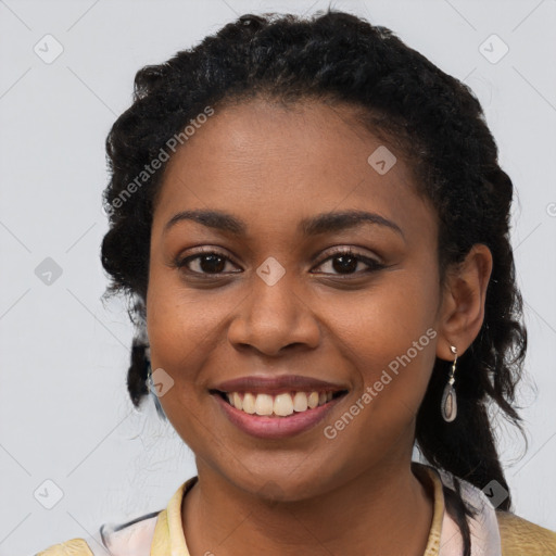 Joyful black young-adult female with long  black hair and brown eyes