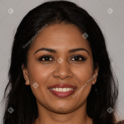 Joyful black young-adult female with long  brown hair and brown eyes