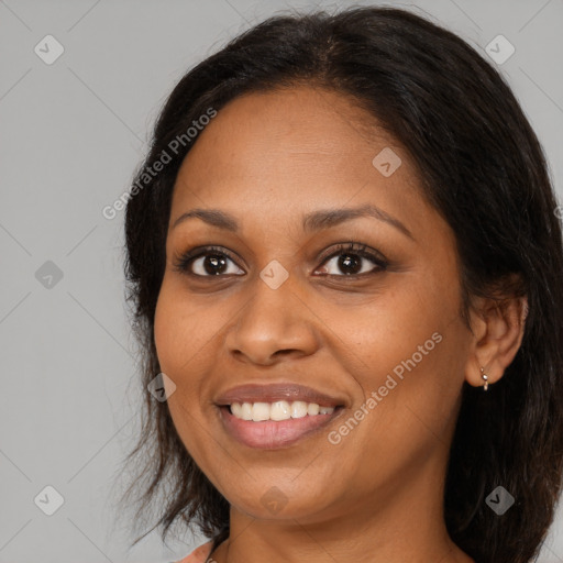 Joyful black adult female with medium  brown hair and brown eyes