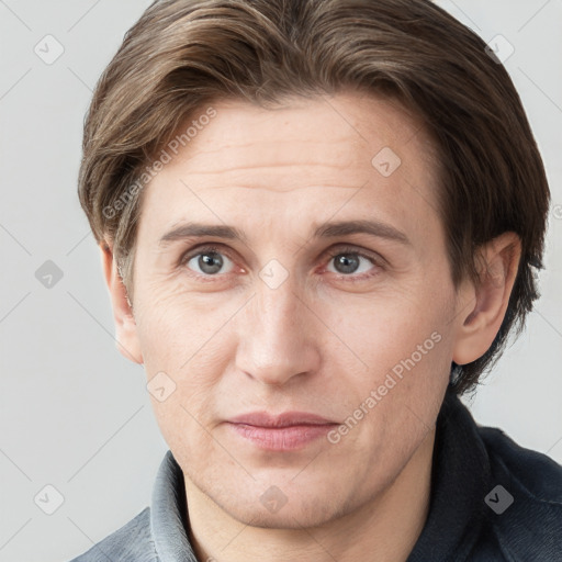 Joyful white adult male with short  brown hair and grey eyes