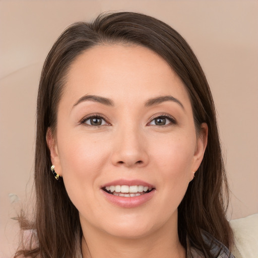 Joyful white young-adult female with long  brown hair and brown eyes