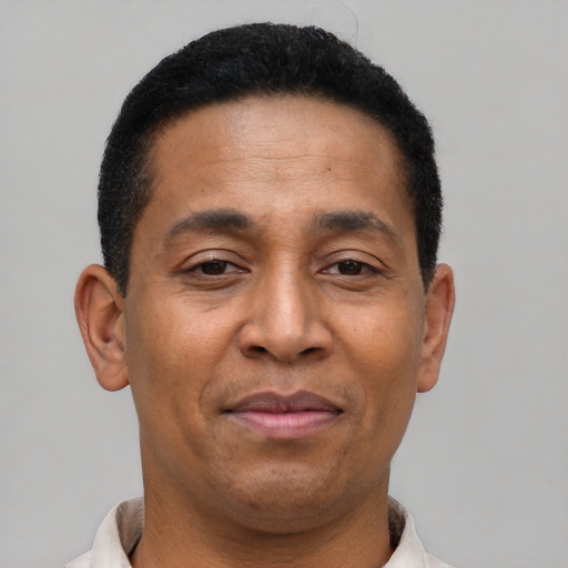 Joyful latino adult male with short  brown hair and brown eyes